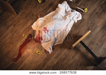 Top View Dead Body Covered With White Sheet At Crime Scene