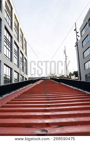 Red Stairs Leading To Sky Between Modern Office Buildings, Coworking And Working Space Concept
