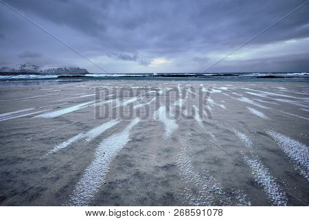 Rocky coast of fjord of Norwegian sea in winter. Skagsanden beach, Lofoten islands, Norway