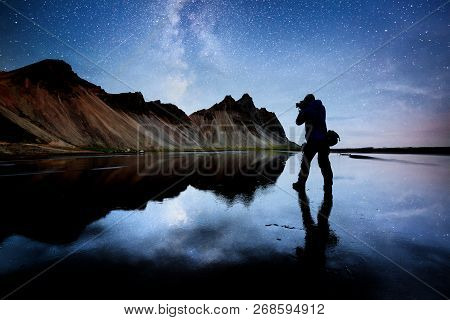 Amazing Mountains Reflected In The Water At Starry Night. Stoksnes, Iceland. Silhouette Of The Natur