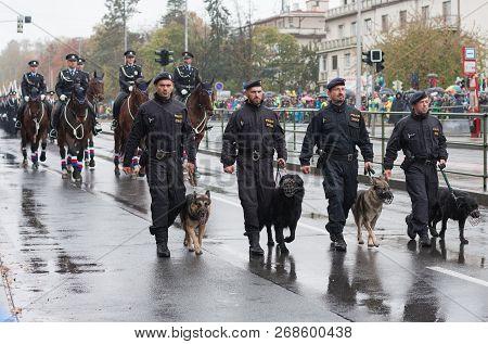 European Street, Prague-october 28, 2018: Police Workers With Service Dogs Are Marching On Military 