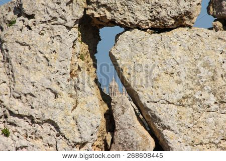 View Of Big Church Dome Through Hole In Blurred Giant Ancient Stones Ggantija Temples On Gozo Island