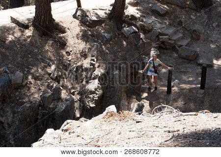 The Inyo Earthquake Fault In Mammoth Lakes California, Female Explores The Area, Showing The Scale O