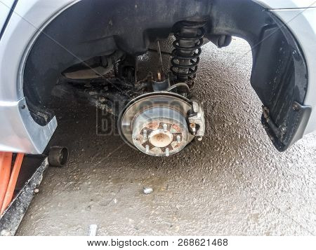 Hub With Brake Disc And Brake Shoes. The Arch Of The Car With The Removed Wheel