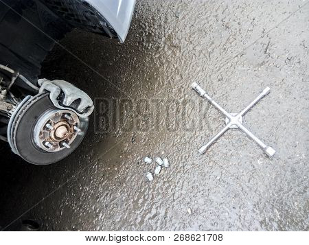The Car Is At The Tire Shop. Under The Jack The Car In Car-care Center. The Car With The Removed Whe