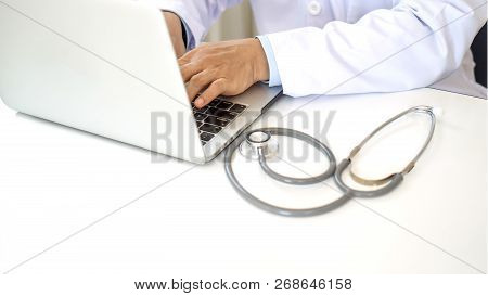 Close-up Of Doctor Hands Typing On Laptop Computer A Medical Worker Sitting On The White Table - Med