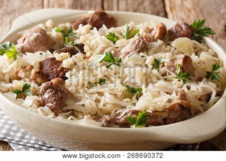 Rustic Style Estonian Mulgikapsas Stewed Pork With Sauerkraut, Onions And Barley Closeup In A Dish.