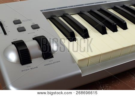 Musical Instrument - Sloseup Fragment Midi Piano 61 Key Keyboard On A Wooden Background