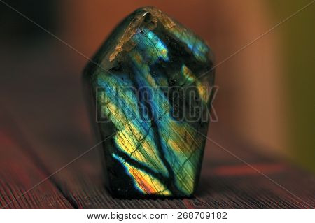 Polished Blue Labradorite On A Wooden Background