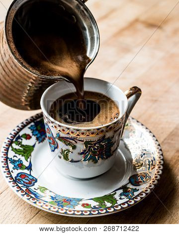 Pouring Turkish Coffee Into The Cup.
