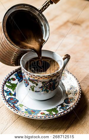 Pouring Turkish Coffee Into The Cup.