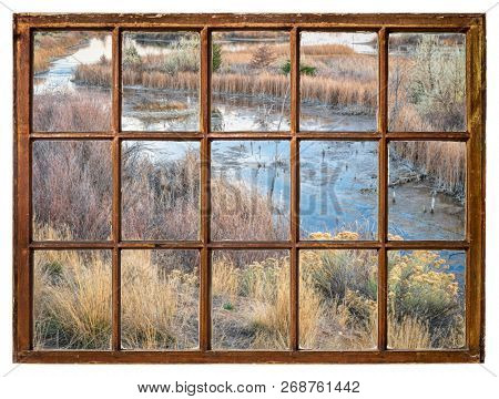 fall scenery in wetlands in northern Colorado as seen from a vintage sahs window