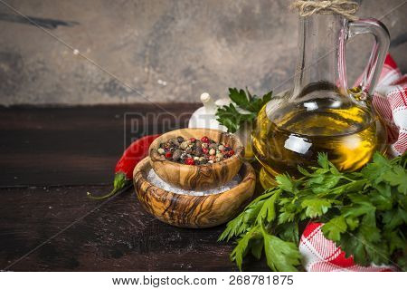 Ingredients For Cooking On Wooden Background. Spices, Herbs And Oil. Free Space For Your Text.