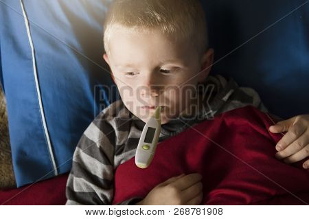 Child Sick In Bed Sleeping And Testing Fever