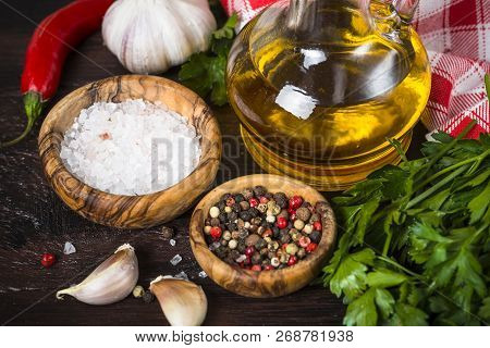 Ingredients For Cooking On Wooden Background. Spices, Herbs And Oil. Free Space For Your Text.