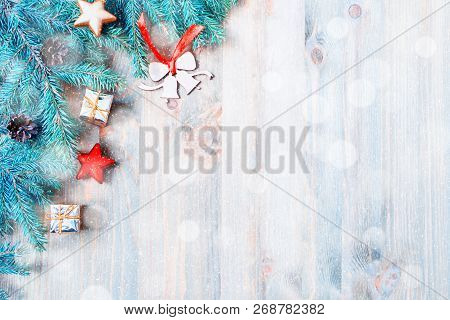 New Year and Christmas background. Christmas toys, blue fir tree branches on the wooden background. New Year and Christmas composition, free space for text, New year and Christmas still life