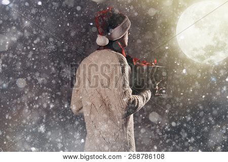 Christmas Gift Concept. Man In Santa Hat Bring Gift For You. Attractive Man Hold Box.  Christmas And