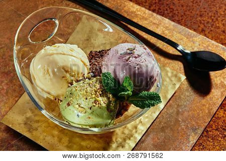 Sorbet in a transparent pial on copper plates close-up. colorful balls of sorbet. series of photos