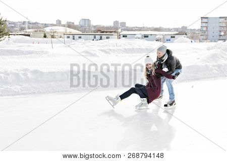 Couple In Sunny Winter Nature Ice Skating