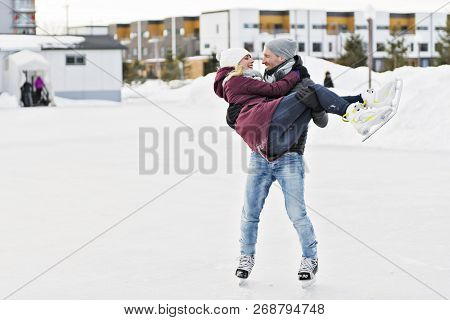 Couple In Sunny Winter Nature Ice Skating