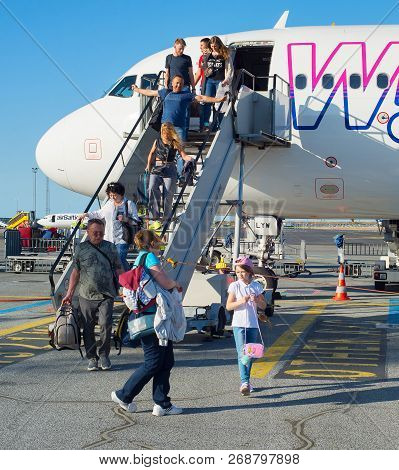 Copenhagen, Denmark - Jun 13, 2018: People Leave An Airplane At An Airport. Copenhagenis The Capital