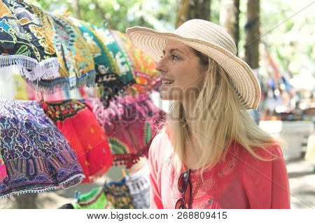 Woman With Colorful Clothes Outdoors At Typical Traditional Market