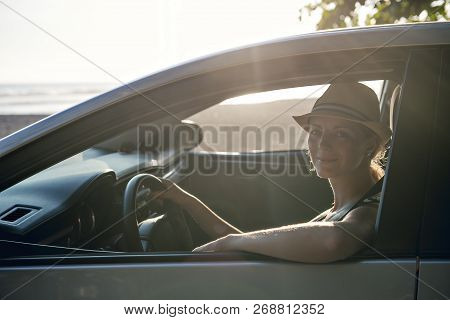 Woman Sitting In A Rental Car On Holiday Vacancy