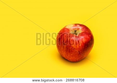Big Red Apple With Yellow Background, Isolated.