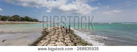 Panorama Of Boys Fishing On The Pier Of Seminyak On Bali, Indonesia