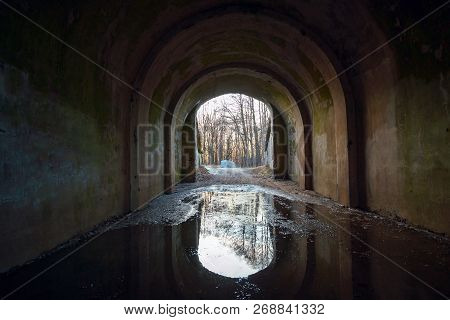 Old Road With Puddles Under The Arch.