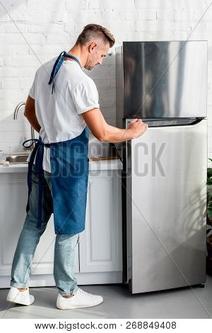 View Of Adult Man Opening Friedge Door