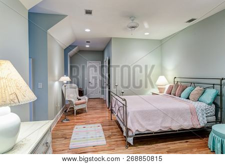 Tasteful attic bedroom with hard wood floors