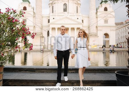 Happy Couple Walking In The Austria, Viena. They Love Each Other And Spent Time Together
