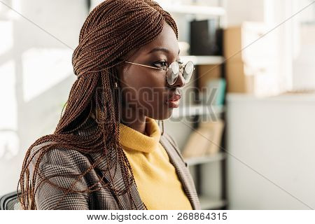 Portrait Of Stylish African American Adult Businesswoman In Formar Wear And Round Glasses