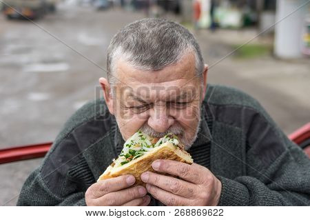 Caucasian Senior Driver Eating Lyulya Kebab In Lavash Near His Car