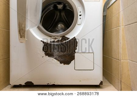 A Rusty Washing Machine In The Interior.