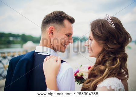 Stylish Bride And Groom Posing On The Background Of The River.