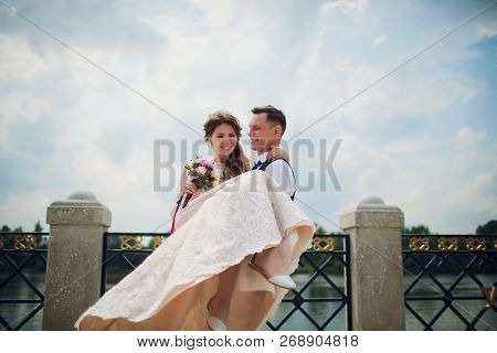 Stylish Bride And Groom Posing On The Background Of The River.