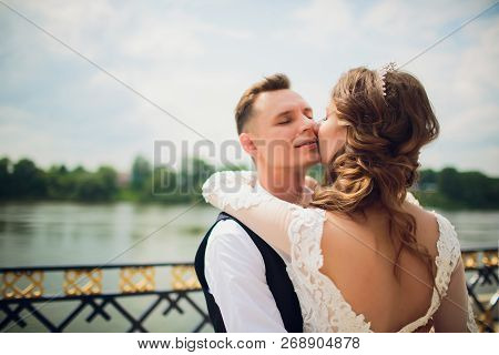 Stylish Bride And Groom Posing On The Background Of The River.