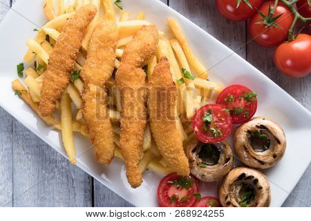 Deep fried chicken frites with potato chips or french fries