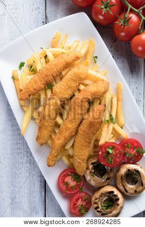 Deep fried chicken frites with potato chips or french fries