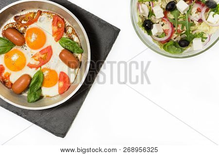 Scrambled Eggs And Salad. Fried Eggs In The Pan.