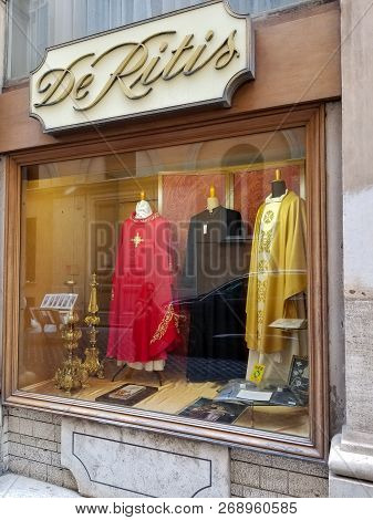 Rome, Italy - May 2018: Red, Black And Golden Cassocks In Showcase Of Clothing Store For Priests De 