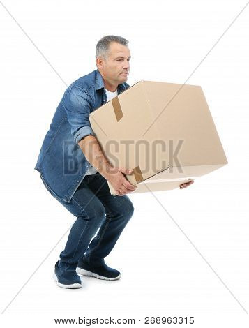 Full Length Portrait Of Mature Man Lifting Carton Box On White Background. Posture Concept