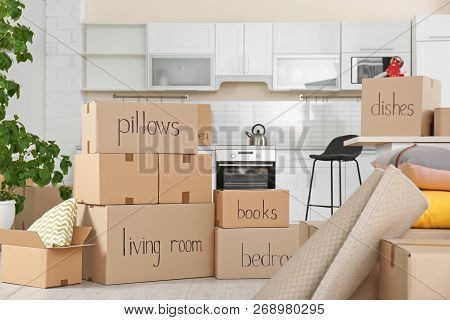 Cardboard Boxes And Household Stuff In Kitchen. Moving Day