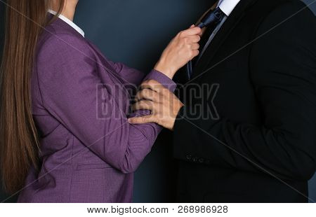 Woman Molesting Her Male Colleague On Dark Background, Closeup. Sexual Harassment At Work