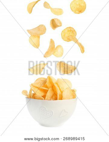 Tasty Potato Chips Falling Into Blow On White Background