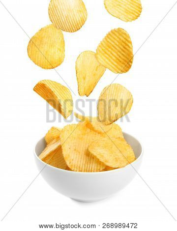 Tasty Potato Chips Falling Into Blow On White Background