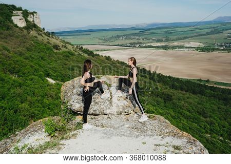 Girls Play Sports In The Mountains. Sport On The Pro-prod. Fitness In The Woods. Yoga In Nature.