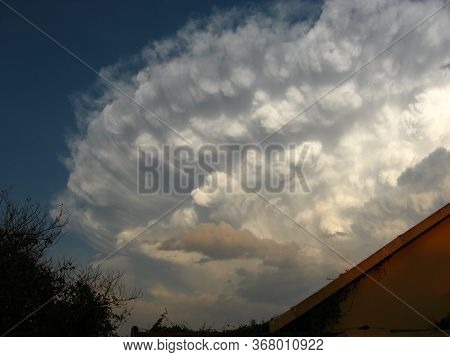 A Huge Cumulo-nimbus Thunderstorm Cloud Building Up Overhead.